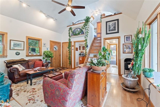 393 Timberlake Ln, Eureka Springs, AR 72631 - living area with rail lighting, ceiling fan, wood finished floors, stairway, and high vaulted ceiling