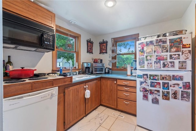 393 Timberlake Ln, Eureka Springs, AR 72631 - kitchen with white appliances, healthy amount of natural light, brown cabinetry, and light marble finish flooring