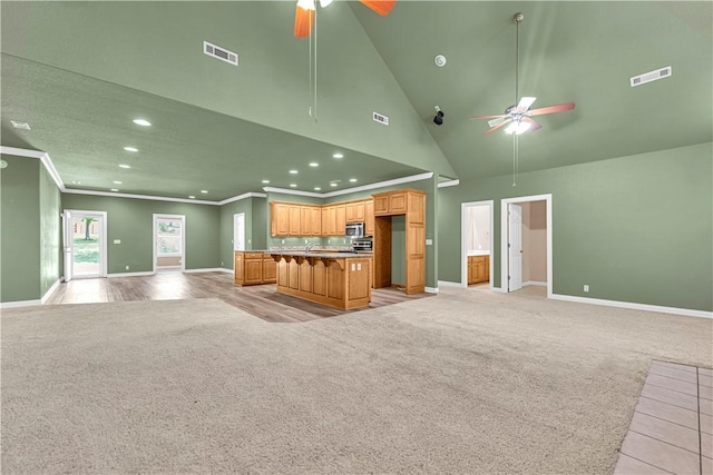 141 Hawn Ave, Huntsville, AR 72738 - unfurnished living room with ceiling fan, light carpet, recessed lighting, ornamental molding, and high vaulted ceiling