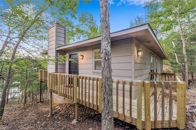 21271 Maple Dr, Garfield, AR 72732 - view of side of property with a wooden deck and a chimney