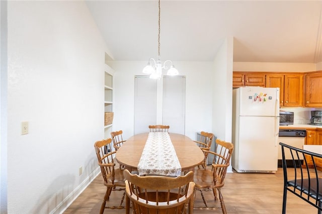 21271 Maple Dr, Garfield, AR 72732 - dining area featuring a chandelier and light wood-type flooring