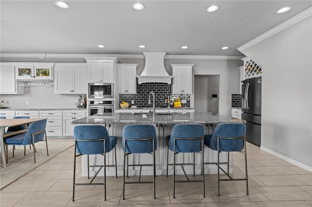 801 Bellmara Cir, Cave Springs, AR 72718 - kitchen featuring premium range hood, stainless steel appliances, ornamental molding, backsplash, and white cabinets