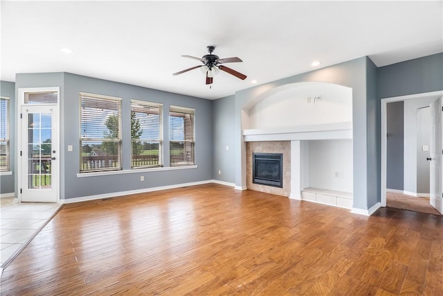 13449 Loyle Ln, Gravette, AR 72736 - unfurnished living room featuring a ceiling fan, wood finished floors, a fireplace, and recessed lighting