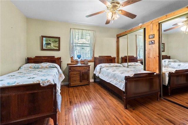 617 County Road 736, Berryville, AR 72616 - bedroom with wood-type flooring, ceiling fan, and two closets