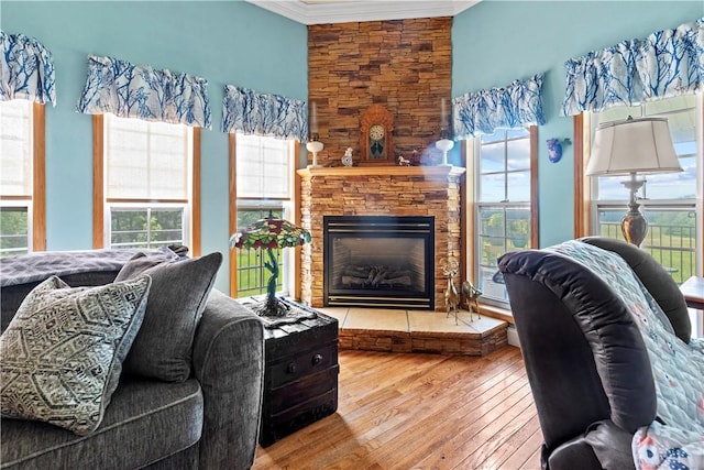 617 County Road 736, Berryville, AR 72616 - living room with hardwood / wood-style flooring, crown molding, and a stone fireplace
