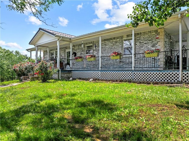 617 County Road 736, Berryville, AR 72616 - view of front of home featuring a porch, a front lawn, stone siding, and a metal roof