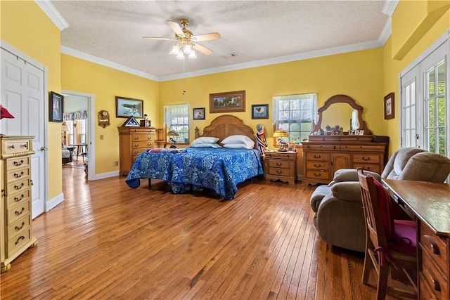 617 County Road 736, Berryville, AR 72616 - bedroom featuring wood-type flooring, a textured ceiling, ornamental molding, and ceiling fan