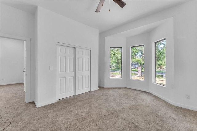 408 SW 2nd Ave, Gravette, AR 72736 - unfurnished bedroom featuring carpet, a closet, and ceiling fan