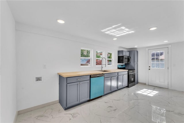 408 SW 2nd Ave, Gravette, AR 72736 - kitchen with appliances with stainless steel finishes, light marble finish floors, healthy amount of natural light, gray cabinets, and recessed lighting