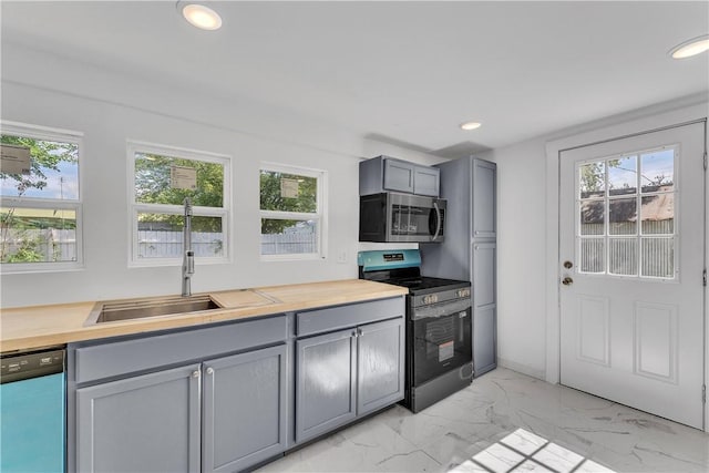 408 SW 2nd Ave, Gravette, AR 72736 - kitchen featuring stainless steel appliances, gray cabinets, light marble finish floors, recessed lighting, and butcher block countertops