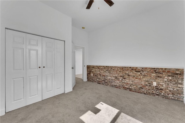 408 SW 2nd Ave, Gravette, AR 72736 - unfurnished bedroom with carpet flooring, a closet, brick wall, and a ceiling fan