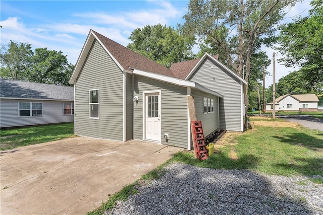 408 SW 2nd Ave, Gravette, AR 72736 - exterior space with a yard, a patio area, and roof with shingles
