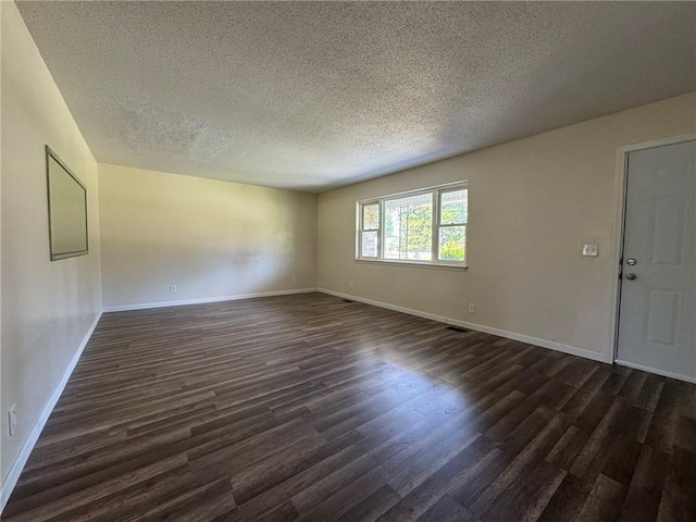 811 Overlook Dr, Mountain Home, AR 72653 - empty room with dark wood-type flooring and a textured ceiling
