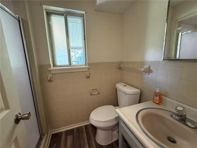 811 Overlook Dr, Mountain Home, AR 72653 - full bath with tile walls, a stall shower, wood finished floors, vanity, and a wainscoted wall
