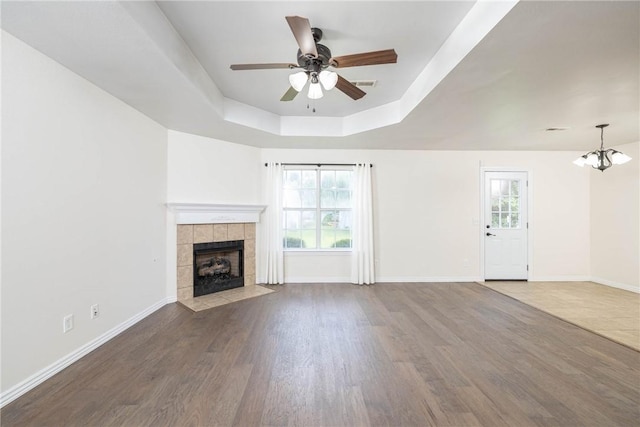 374 Meszaros Ct, Pea Ridge, AR 72751 - unfurnished living room with a tray ceiling, healthy amount of natural light, a ceiling fan, and a chandelier