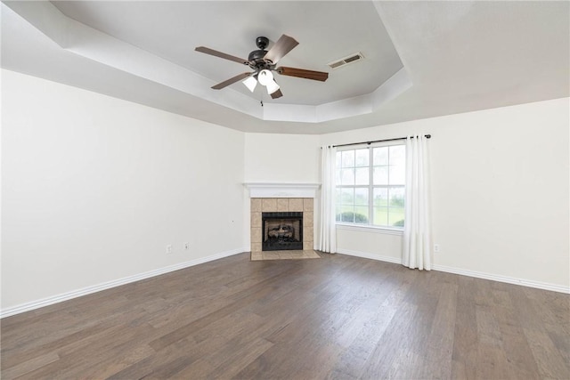 374 Meszaros Ct, Pea Ridge, AR 72751 - unfurnished living room with a tray ceiling, wood finished floors, ceiling fan, and a tiled fireplace