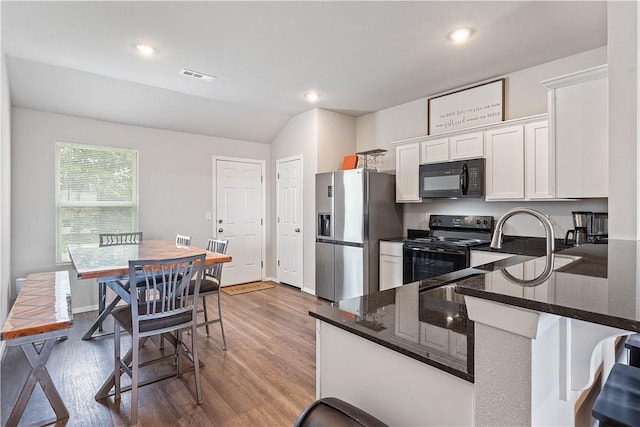 2586 Chittick St, Pea Ridge, AR 72751 - kitchen featuring black appliances, white cabinetry, wood finished floors, lofted ceiling, and dark stone counters