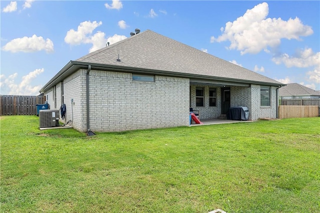 1001 Kimball Ln, Pea Ridge, AR 72751 - back of property featuring a fenced backyard, brick siding, a patio, and a shingled roof