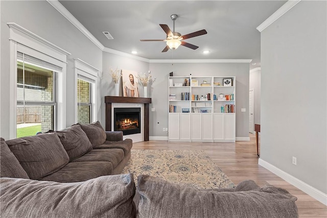1001 Kimball Ln, Pea Ridge, AR 72751 - living room featuring ornamental molding, a ceiling fan, light wood-style floors, recessed lighting, and a lit fireplace