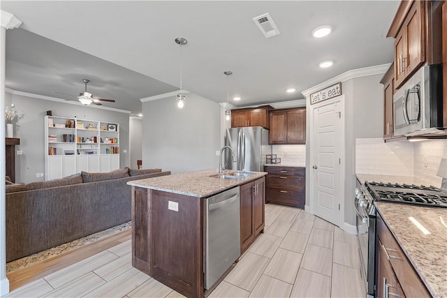 1001 Kimball Ln, Pea Ridge, AR 72751 - kitchen featuring stainless steel appliances, crown molding, decorative backsplash, an island with sink, and light stone countertops