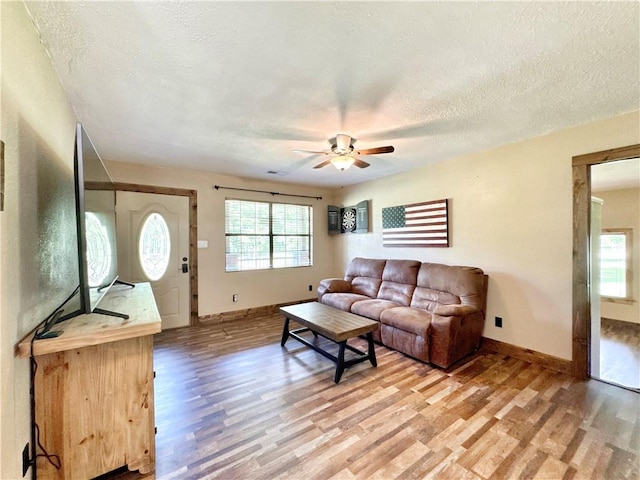 8500 Rock Creek Rd, Mulberry, AR 72947 - living area with light wood finished floors, a textured ceiling, and ceiling fan
