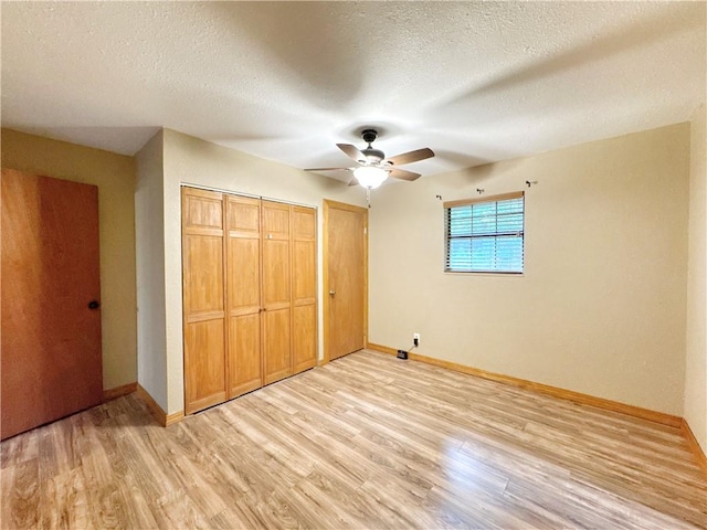 8500 Rock Creek Rd, Mulberry, AR 72947 - unfurnished bedroom featuring light wood finished floors, a textured ceiling, and ceiling fan