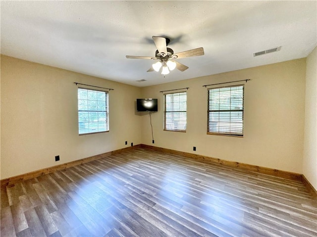 8500 Rock Creek Rd, Mulberry, AR 72947 - unfurnished room featuring wood finished floors, healthy amount of natural light, and ceiling fan