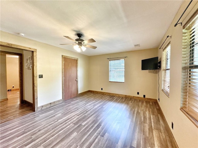 8500 Rock Creek Rd, Mulberry, AR 72947 - unfurnished bedroom with wood finished floors and a ceiling fan
