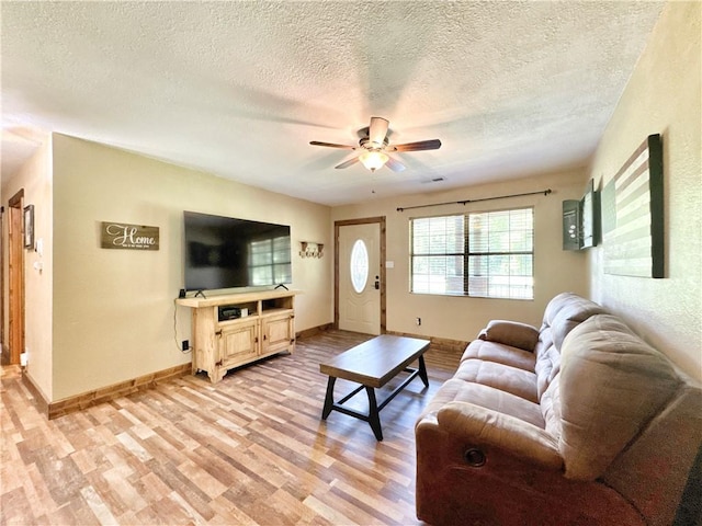 8500 Rock Creek Rd, Mulberry, AR 72947 - living area featuring light wood-style flooring, a ceiling fan, and a textured ceiling