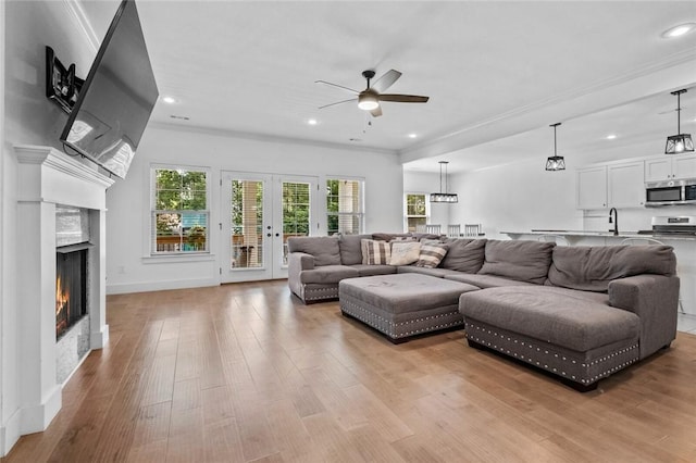 108 Dobson St, Pea Ridge, AR 72751 - living area with ceiling fan, a warm lit fireplace, light wood-type flooring, recessed lighting, and ornamental molding