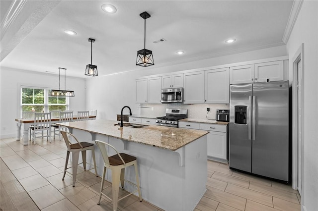 108 Dobson St, Pea Ridge, AR 72751 - kitchen with appliances with stainless steel finishes, decorative backsplash, a breakfast bar area, light stone counters, and recessed lighting