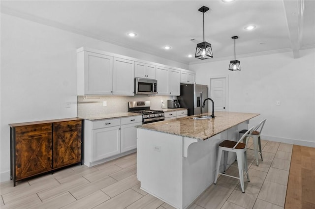 108 Dobson St, Pea Ridge, AR 72751 - kitchen featuring appliances with stainless steel finishes, a kitchen bar, tasteful backsplash, white cabinets, and ornamental molding
