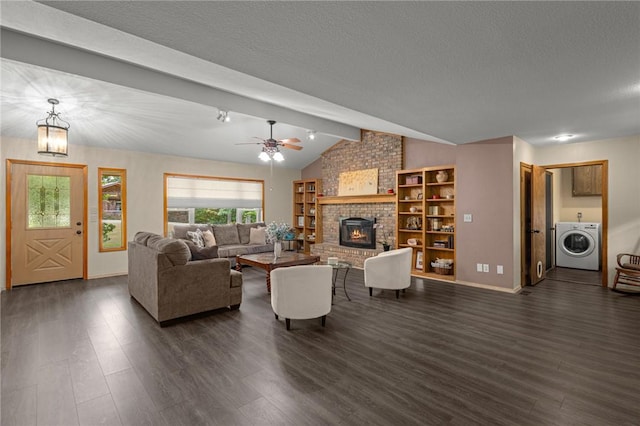 9382 Grimes Dr, Rogers, AR 72756 - living area featuring washer / clothes dryer, a fireplace, dark wood-style flooring, ceiling fan, and a textured ceiling