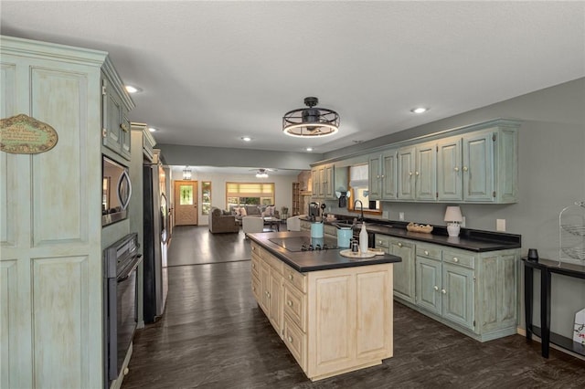 9382 Grimes Dr, Rogers, AR 72756 - kitchen featuring black appliances, dark countertops, open floor plan, dark wood-type flooring, and recessed lighting