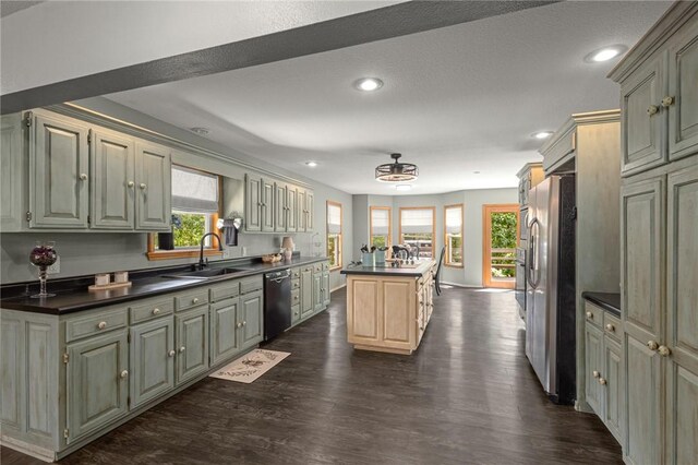 9382 Grimes Dr, Rogers, AR 72756 - kitchen with dishwasher, freestanding refrigerator, dark wood-style flooring, dark countertops, and recessed lighting
