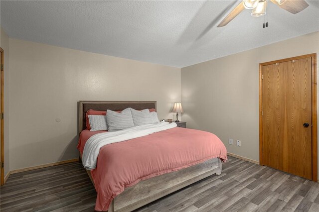 9382 Grimes Dr, Rogers, AR 72756 - bedroom featuring wood finished floors, a ceiling fan, and a textured ceiling