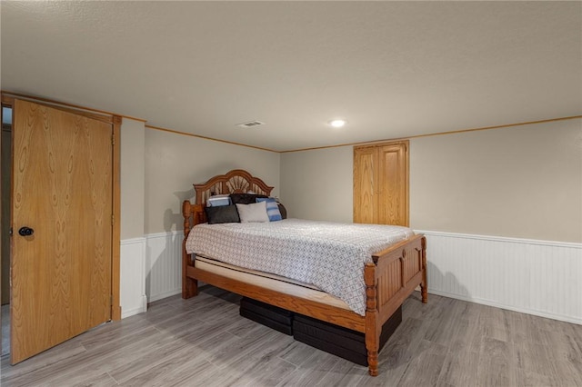 9382 Grimes Dr, Rogers, AR 72756 - bedroom featuring a wainscoted wall and light wood-style flooring