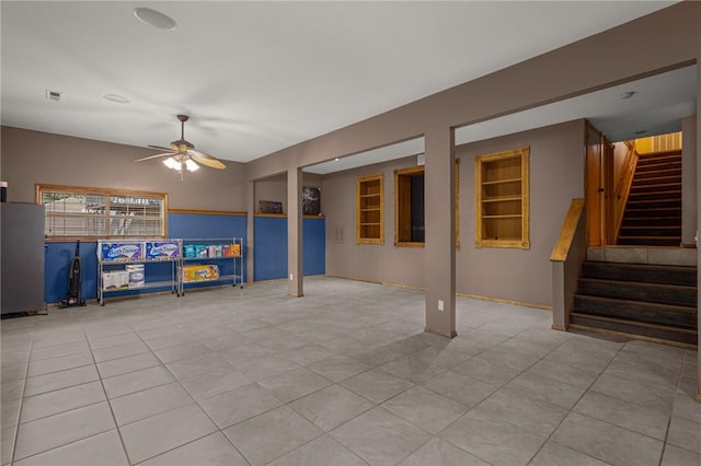 9382 Grimes Dr, Rogers, AR 72756 - unfurnished living room with stairway, a ceiling fan, and tile patterned floors
