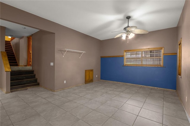 9382 Grimes Dr, Rogers, AR 72756 - tiled empty room with ceiling fan and stairs