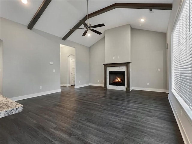 217 Idaho Ave, Farmington, AR 72730 - unfurnished living room with a ceiling fan, beamed ceiling, a warm lit fireplace, high vaulted ceiling, and dark wood-style flooring