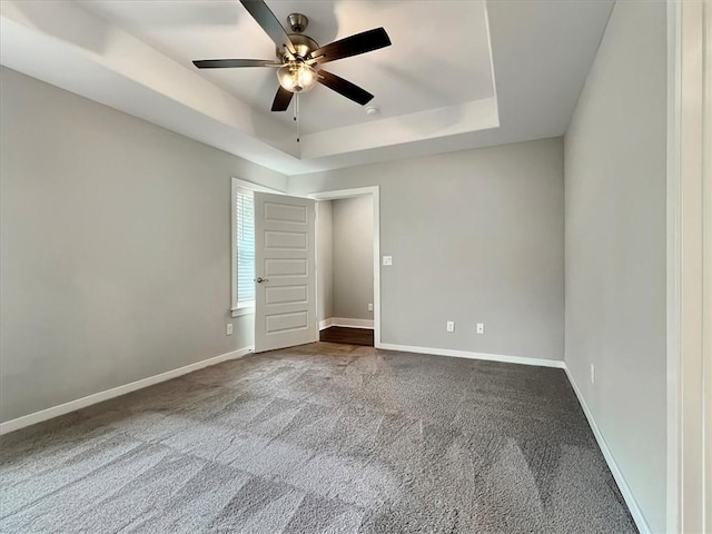 217 Idaho Ave, Farmington, AR 72730 - unfurnished room featuring dark colored carpet, ceiling fan, and a tray ceiling