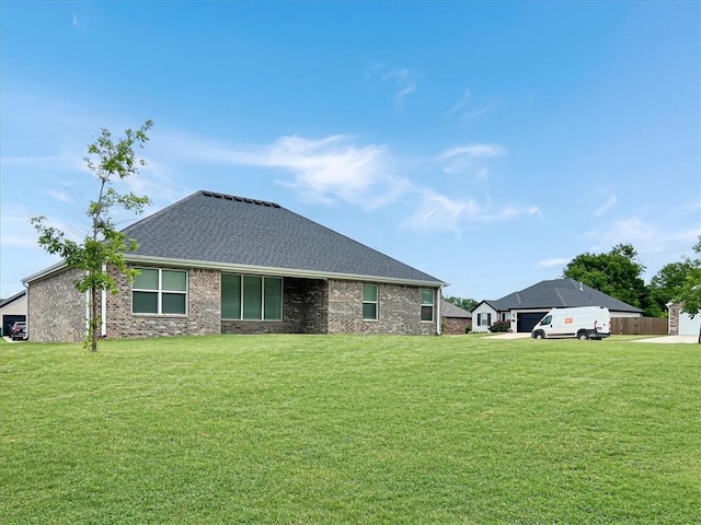 217 Idaho Ave, Farmington, AR 72730 - back of house featuring a yard, roof with shingles, and brick siding