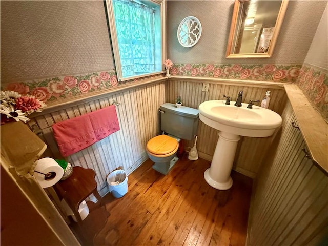 16 Nut St, Eureka Springs, AR 72632 - half bath featuring wallpapered walls, wood-type flooring, and wainscoting