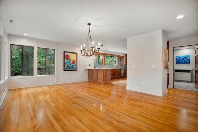 1018 N Canterbury Rd, Fayetteville, AR 72701 - unfurnished living room with a chandelier, light wood-style floors, and recessed lighting