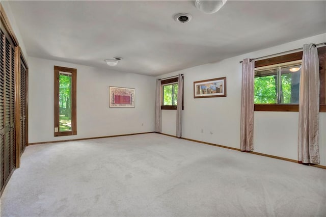 1018 N Canterbury Rd, Fayetteville, AR 72701 - unfurnished bedroom with light carpet and multiple windows