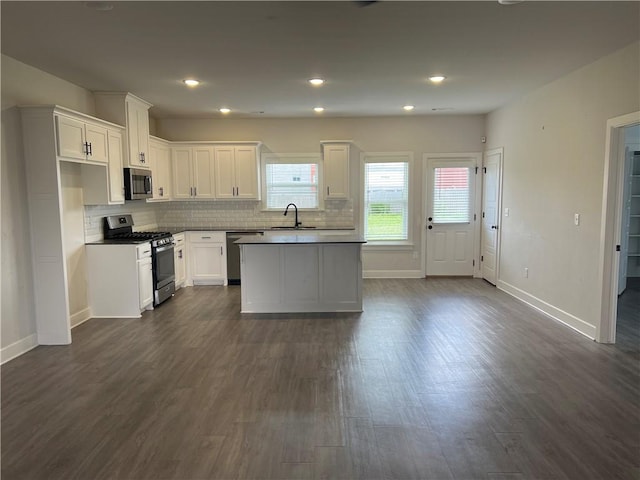 1340 Mt Hood Dr, Centerton, AR 72719 - kitchen with stainless steel appliances, plenty of natural light, dark wood-style flooring, white cabinets, and recessed lighting