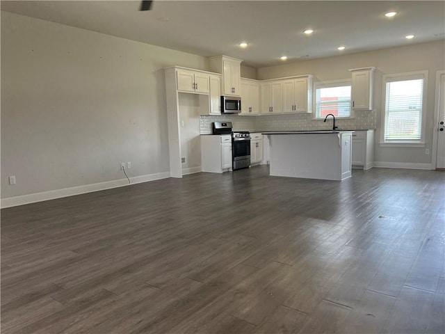1340 Mt Hood Dr, Centerton, AR 72719 - kitchen with appliances with stainless steel finishes, open floor plan, white cabinetry, tasteful backsplash, and recessed lighting