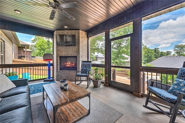 1208 Hickory St, Cave Springs, AR 72718 - sunroom / solarium featuring ceiling fan, plenty of natural light, and an outdoor living space with a fireplace
