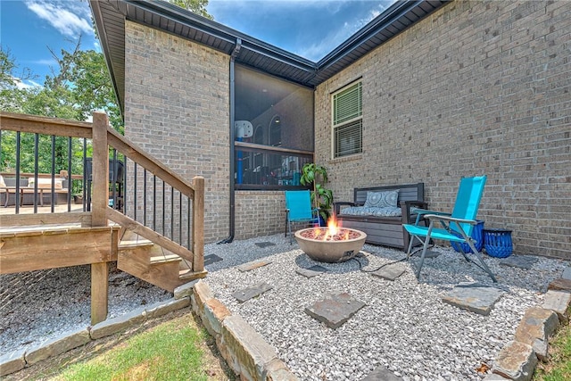 1208 Hickory St, Cave Springs, AR 72718 - view of patio featuring a fire pit and a deck