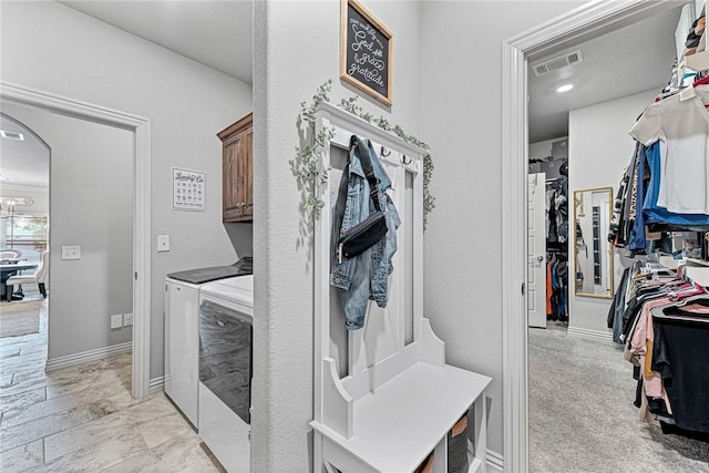 1208 Hickory St, Cave Springs, AR 72718 - laundry room featuring independent washer and dryer, cabinet space, and arched walkways